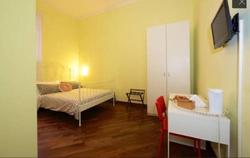 a room with two beds and a tv on a wall at Una Piacevole Sorpresa in Bari