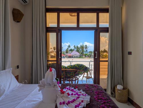 a bedroom with a bed with a wedding cake on it at Villa Goli Paje in Paje