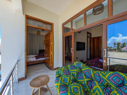 a room with a bed and a balcony at Villa Goli Paje in Paje