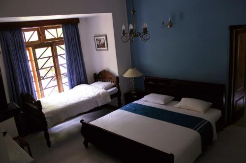En eller flere senge i et værelse på Hotel Mount Pleasant