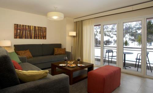 a living room with a couch and a table at Village Condo in San Carlos de Bariloche