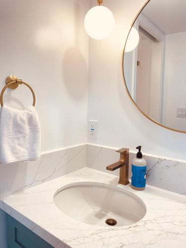 a bathroom with a sink and a mirror at Newly renovated luxury, modern style Waikiki Sunset Hotel Ocean view Freeparking in Honolulu