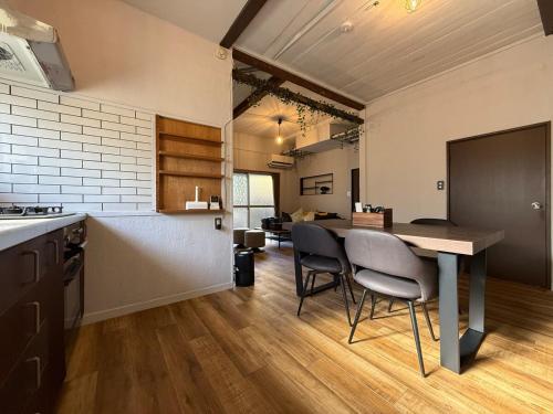 a kitchen and living room with a table and chairs at 5 min Walk Noborito 16 mins Shinjuku,3 BR, 2 Bath in Kawasaki
