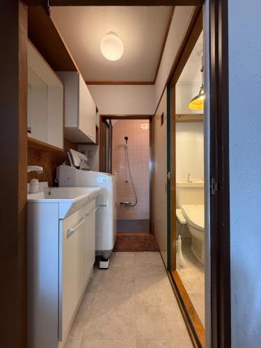 a bathroom with a sink and a toilet in it at 5 min Walk Noborito 16 mins Shinjuku,3 BR, 2 Bath in Kawasaki