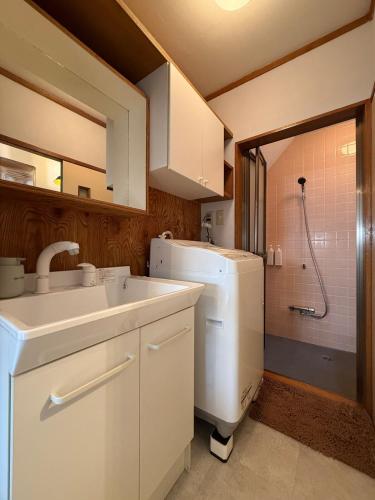 a kitchen with a sink and a refrigerator and a shower at 5 min Walk Noborito 16 mins Shinjuku,3 BR, 2 Bath in Kawasaki