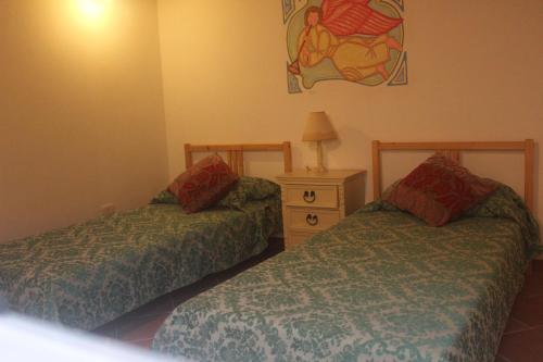 a bedroom with two beds and a dresser and a painting at Dimora d'epoca "Ideale per Coppie" in Avola