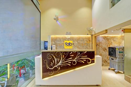 a room with a counter with a sign on the wall at FabHotel Morya Regency - Bhopal railway station platform no 6 in Bhopal