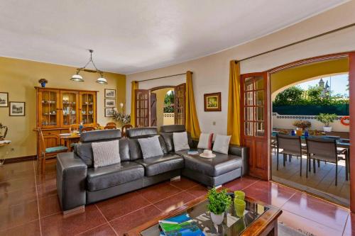 a living room with a couch and a table at Villa Isabel by Villa Plus in Carvoeiro