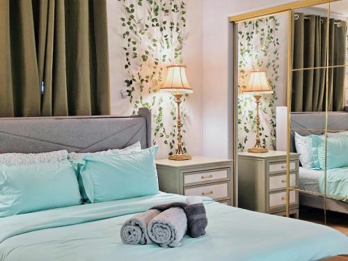 a bedroom with a bed with towels on it at Exquisite jazzy warm deco nearby the Strip - Top 15 Best Vegas Vacation Home recommended by Conde Nast Traveler in Las Vegas