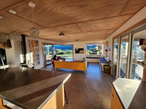 a living room with a couch and a table at Stony Ridge Summer Stay in Motueka