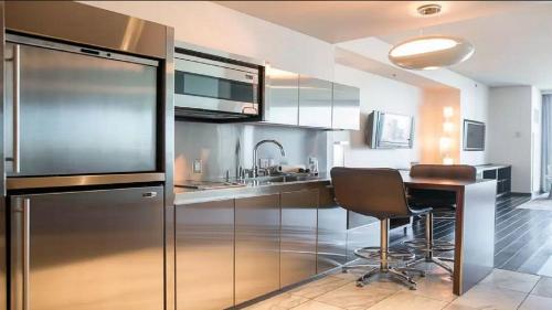 a kitchen with a refrigerator and a table in it at Palms place 51st floor & strip view in Las Vegas