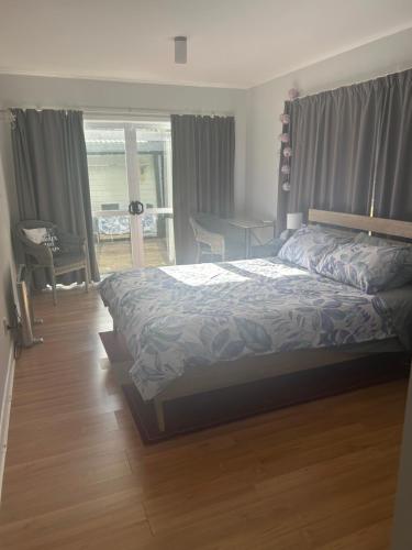 a bedroom with a bed in a room with a window at Robert ST Newlands in Wellington