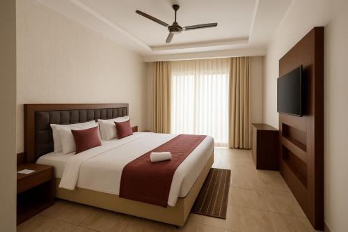 a bedroom with a large bed and a flat screen tv at Xenious Opulent Hamirpur in Hamīrpur