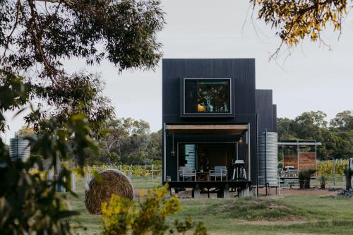 a modern house with a black facade at Barn Hives Yallingup in Yallingup