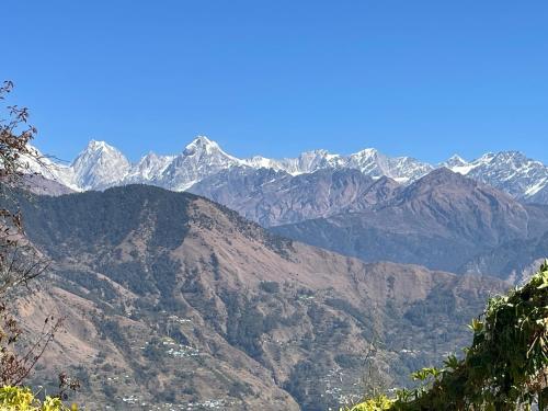 a view of a mountain range with snow covered mountains at Munsiyari ECO homestay in Munsyari