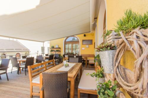 a restaurant with tables and chairs and plants at Hotel Gasthof Zum Kirchenwirt in Puch bei Hallein