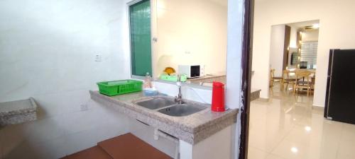 une salle de bain avec un lavabo et un miroir dans l'établissement Spacious 3-Room Home in Miri, à Miri