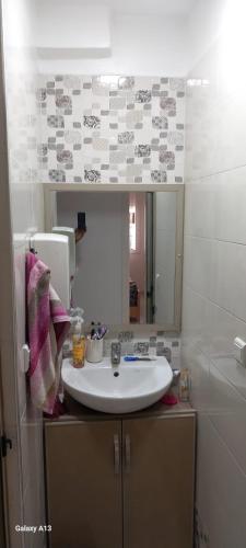 a bathroom with a white sink and a mirror at Zaafrani mohamed in El Jadida