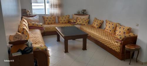 a living room with a couch and a table at Zaafrani mohamed in El Jadida