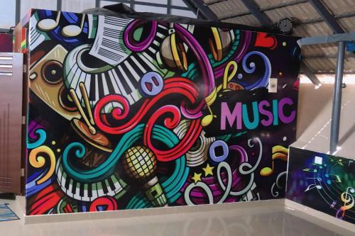 a colorful wall with music painted on it at Casavalley in Anachal