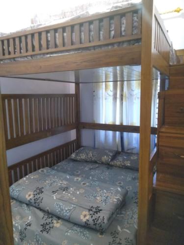 a bunk bed in a room with a ladder at Manggala Homestay Bromo in Ngadisari