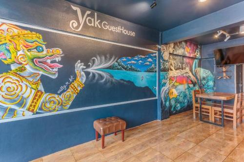 a room with a large painting on the wall at The Yak Cozy Chiang Mai in Chiang Mai