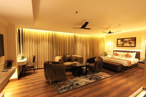 a living room with a bed and a couch at Hotel Ganga Sutra in Haridwār