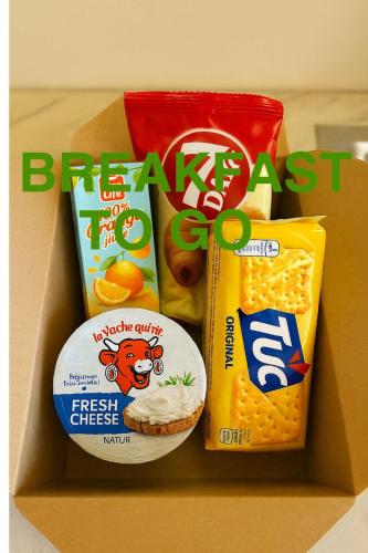 a box filled with snacks and other food at Dona Premier Suites in Bucharest