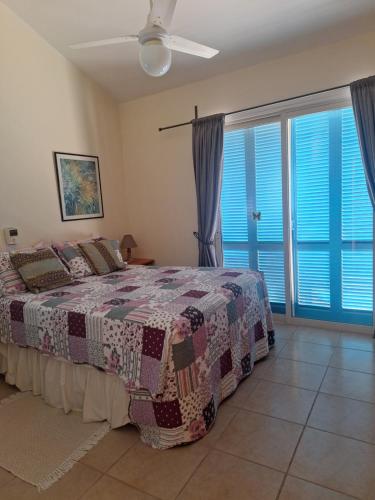 ein Schlafzimmer mit einem Bett und einem großen Fenster in der Unterkunft Melanta Villa in Pissouri