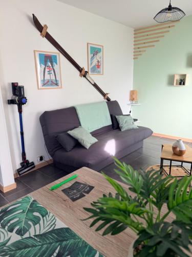 a living room with a couch and a table at Très bel appartement au cœur des Vosges in Saulcy-sur-Meurthe