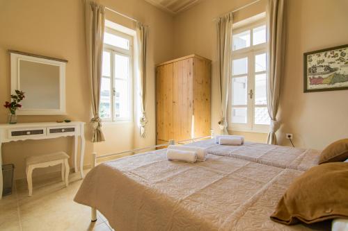 a bedroom with two beds and two windows at Rena's House in Spílion