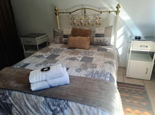 ein Schlafzimmer mit einem Bett und einem Handtuch darauf in der Unterkunft Sundown Lodge and Confrence in Aliwal North