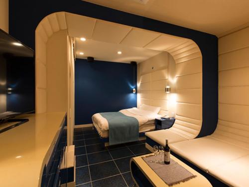 a hotel room with a bed and a table at HOTEL PARIET Nakagawa - Adult Only in Fukuoka