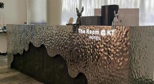 a metal counter with a sign on top of it at THE ROOM @ KT HOTEL in Kuala Terengganu