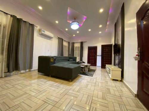 a living room with a couch and a table at ftrealtyproperties Lords Hill 13 in Tokuse