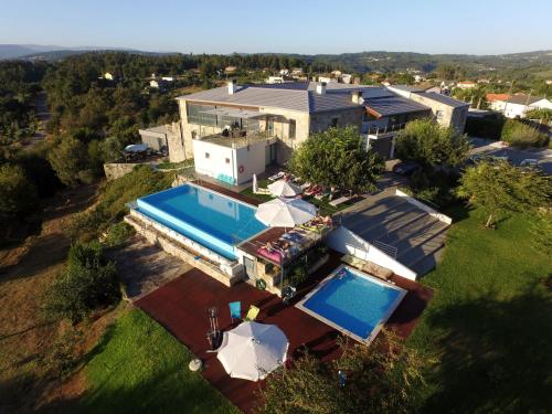 an aerial view of a house with a swimming pool at Paço da Torre de Figueiredo das Donas in Figueiredo das Donas