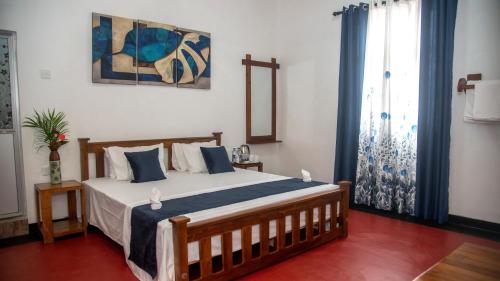 Ένα ή περισσότερα κρεβάτια σε δωμάτιο στο Sigiriya Agrarian Haven