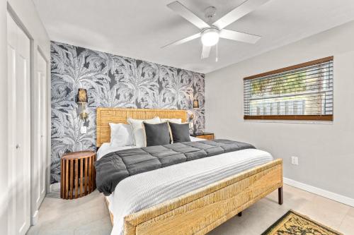 a bedroom with a large bed with a ceiling fan at Beach Walk Cottage - 451 in Siesta Key