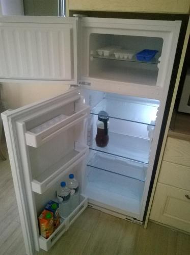an open refrigerator with its door open and food inside at Nikoloudi Estate in Agios Nikolaos
