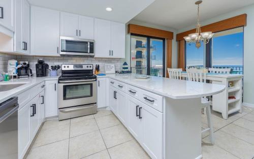 a kitchen with white cabinets and a counter top at Phoenix VI 61115 in Orange Beach