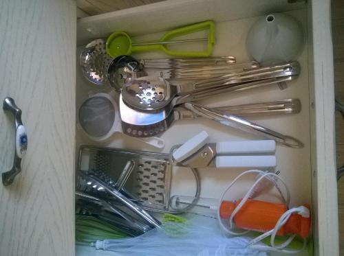 a drawer full of kitchen utensils in a cabinet at Nikoloudi Estate in Agios Nikolaos