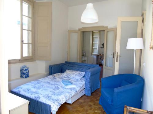 a small room with a blue bed and a blue chair at Il Granaio di Palazzo Guicciardi in Ponte in Valtellina