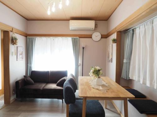 a living room with a couch and a table at Haku Nest Ichinoe in Tokyo