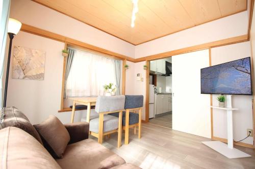 a living room with a couch and a table at Haku Nest Ichinoe in Tokyo
