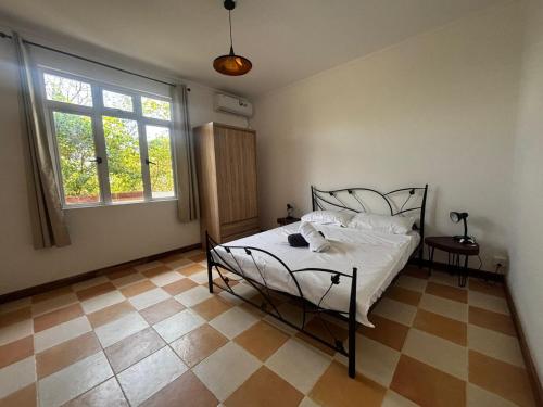 a bedroom with a bed and a tiled floor at L'Escapade - Residence Harmonie in Albion