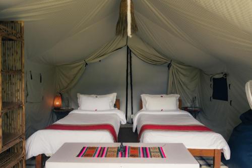 a group of three beds in a tent at Know About Destinations in Kathmandu