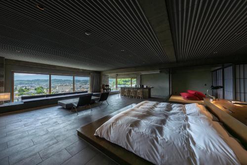 a bedroom with a large bed and a large window at Matsumoto Jujo in Matsumoto