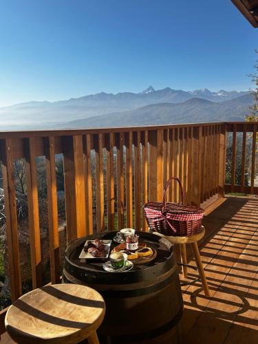 a patio with a table and chairs on a deck at Agriturismo Dai Dellerba in Pinerolo