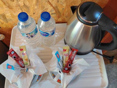 a table with a tea kettle and two bottles of water at Nathan Breeze Resort in Ko Muk