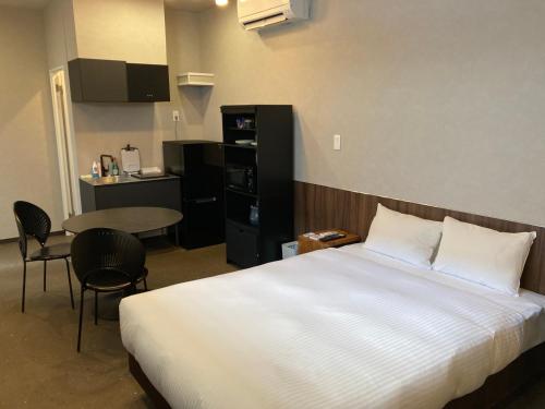 Postel nebo postele na pokoji v ubytování クリスタルパーク久松